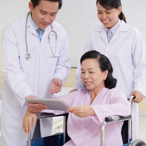 Reading prescription Cheerful aged woman reading doctors presctiption on digital tablet